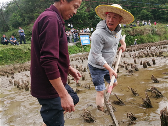 姚俊杰（右）为农户示范鱼沟的开挖.png