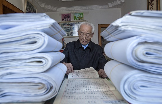 2018年12月2日，贵州省黔西县水西街道85岁老通讯员李元章查阅几十年前的底稿，前面也是厚厚的底稿。IMG_6696.jpg