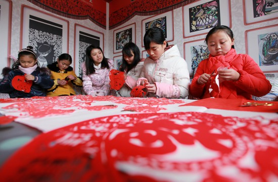 贵州省毕节市黔西县春晖剪纸艺术班的孩子们在岳红霞的指导下创作迎春作品.jpg